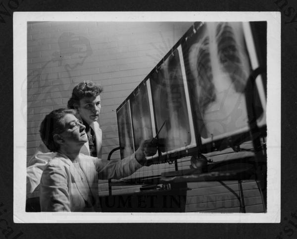 Dr. Miriam Bell reading the results of a student's chest x-ray, 1947 (The Legacy Center Archives and Special Collections)